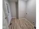 Laundry room with durable vinyl flooring, neutral wall paint, and a glass paneled door with silver fixtures at 724 Iroquois St, Anderson, IN 46012