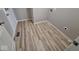 Bright laundry room featuring durable wood-style vinyl flooring and neutral walls with accessible outlet at 724 Iroquois St, Anderson, IN 46012