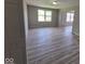 A spacious living room with large windows, durable floors, and an open layout at 724 Iroquois St, Anderson, IN 46012