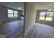 An open-concept room with bright windows, a doorway to the kitchen, and durable floors at 724 Iroquois St, Anderson, IN 46012
