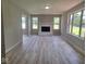 Bright living room featuring a white brick fireplace and large windows for ample natural light at 724 Iroquois St, Anderson, IN 46012