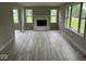 Spacious living room with a fireplace, new flooring, and large windows at 724 Iroquois St, Anderson, IN 46012