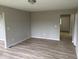 Room with neutral paint, wood-look floors, and plenty of natural light at 724 Iroquois St, Anderson, IN 46012