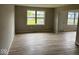 Open room with wood-look flooring, neutral paint, and natural light at 724 Iroquois St, Anderson, IN 46012