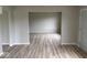 Spacious, open-concept room with wood-look flooring, neutral paint, and plenty of natural light at 724 Iroquois St, Anderson, IN 46012