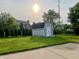 View of a backyard with storage shed, green lawn and mature trees at 7532 Perilla Ct, Indianapolis, IN 46237