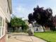 A backyard featuring a patio, grill, white pergola and mature tree at 7532 Perilla Ct, Indianapolis, IN 46237