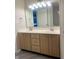 Bathroom featuring a double sink vanity and large mirror at 7532 Perilla Ct, Indianapolis, IN 46237