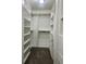 Walk-in closet with custom shelving and drawers for optimal storage at 7532 Perilla Ct, Indianapolis, IN 46237
