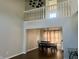 Dining room with a modern chandelier, wood floors, and large windows providing natural light, showcasing an inviting space at 7532 Perilla Ct, Indianapolis, IN 46237
