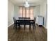 Dining room with dark wood floors, a chandelier, and a wooden table with seating for six, for formal entertaining at 7532 Perilla Ct, Indianapolis, IN 46237
