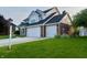 Charming home with brick facade, two-car garage, green lawn, and a small decorative lamp post at the end of the driveway at 7532 Perilla Ct, Indianapolis, IN 46237
