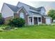 Two-story home featuring brick and gray siding, white trim and a well-manicured front lawn at 7532 Perilla Ct, Indianapolis, IN 46237