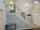 Inviting foyer featuring high ceilings, a staircase, and ample natural light at 7532 Perilla Ct, Indianapolis, IN 46237