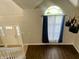 Bright foyer with hardwood floors, staircase and large window providing ample natural light at 7532 Perilla Ct, Indianapolis, IN 46237