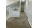 Upstairs hallway featuring neutral colors and a chandelier at 7532 Perilla Ct, Indianapolis, IN 46237