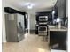 Charming kitchen with stainless steel appliances, dark cabinets, and granite countertops at 7532 Perilla Ct, Indianapolis, IN 46237