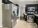 Charming kitchen featuring stainless steel appliances and modern dark cabinetry at 7532 Perilla Ct, Indianapolis, IN 46237