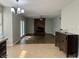 Open-concept living room with a brick fireplace, wood floors, and access to outdoor patio, perfect for relaxation at 7532 Perilla Ct, Indianapolis, IN 46237