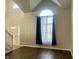 Sun-filled living room with wood floors, large window, and soaring ceilings, creating a spacious and welcoming atmosphere at 7532 Perilla Ct, Indianapolis, IN 46237