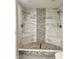 Modern shower featuring dual shower heads and stylish tile with stone accents at 7532 Perilla Ct, Indianapolis, IN 46237