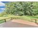 Expansive backyard featuring a lush lawn, mature trees, and a deck, creating an ideal space for outdoor enjoyment at 7583 Rogers Dr, Indianapolis, IN 46214