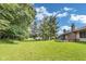 Overlooking lush lawn, tall trees, with a home that invites you to embrace serenity in a spacious outdoor environment at 7583 Rogers Dr, Indianapolis, IN 46214