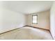 Empty bedroom featuring a large window, neutral tones, and carpet flooring at 7583 Rogers Dr, Indianapolis, IN 46214