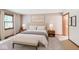 A bright bedroom featuring neutral tones, a large bed, and matching nightstands at 7583 Rogers Dr, Indianapolis, IN 46214