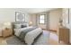Cozy bedroom with large window, neutral tones, and modern furniture at 7583 Rogers Dr, Indianapolis, IN 46214