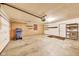Spacious garage featuring a roll-up door, painted walls, concrete flooring and plenty of storage space at 7583 Rogers Dr, Indianapolis, IN 46214