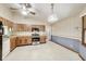 Cozy kitchen with wood cabinets, stainless steel appliances, and vintage wallpaper at 7583 Rogers Dr, Indianapolis, IN 46214