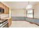 Vintage kitchen with wooden cabinets, stainless steel oven and blue and cream wallpaper at 7583 Rogers Dr, Indianapolis, IN 46214