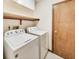 Well-equipped laundry room with a washer, dryer, shelf, and ample space for efficient chore management at 7583 Rogers Dr, Indianapolis, IN 46214