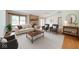 Staged living room featuring a brick fireplace, neutral furniture, and a vaulted ceiling at 7583 Rogers Dr, Indianapolis, IN 46214