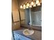 Bright bathroom vanity with a gray speckled countertop and stylish lighting at 7707 River Rd # 10, Indianapolis, IN 46240