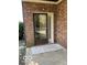 Covered entrance with a storm door, welcome mat and brick facade at 7707 River Rd # 10, Indianapolis, IN 46240