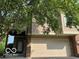 Beige two-story home with a two-car garage and brick accents at 7707 River Rd # 10, Indianapolis, IN 46240