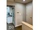 Neutral hallway leading to a kitchen, with hardwood flooring at 7707 River Rd # 10, Indianapolis, IN 46240