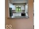 Open kitchen area featuring granite countertop breakfast bar and white cabinetry at 7707 River Rd # 10, Indianapolis, IN 46240