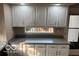 Bright kitchen featuring white cabinets, gray countertops, and modern lighting at 7707 River Rd # 10, Indianapolis, IN 46240