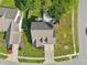 Aerial view shows the roof, backyard with gray deck, surrounding homes and manicured lawn at 7766 Jamestown S S Dr, Fishers, IN 46038