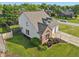 Aerial view of a house with a well-manicured lawn and attached two-car garage at 7766 Jamestown S S Dr, Fishers, IN 46038