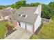 Aerial view of a two-story home with a brick front and two-car garage at 7766 Jamestown S S Dr, Fishers, IN 46038