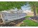 Backyard view shows a well-manicured lawn, wood fence and a large gray deck at 7766 Jamestown S S Dr, Fishers, IN 46038