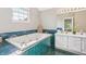 Bathroom boasts a large tub with emerald green tiles and a separate vanity sink at 7766 Jamestown S S Dr, Fishers, IN 46038