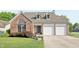 Charming brick home featuring a two-car garage and well-manicured lawn at 7766 Jamestown S S Dr, Fishers, IN 46038