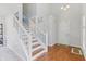Bright foyer with hardwood floors and a staircase with white railings at 7766 Jamestown S S Dr, Fishers, IN 46038