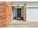 Inviting entryway featuring a black front door with brick and vinyl siding at 7766 Jamestown S S Dr, Fishers, IN 46038