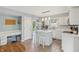 Open kitchen with a central island, white cabinets, a tile floor, and a built-in desk area at 7766 Jamestown S S Dr, Fishers, IN 46038